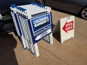 a blue Coldwell Banker sign that says open house