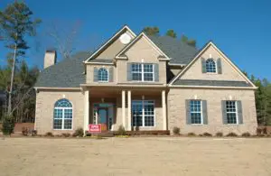 a grey house with a black roof to hold an open house in