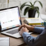 A person looking up lease options and purchase sales on a laptop