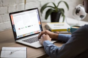 A person looking up lease options and purchase sales on a laptop