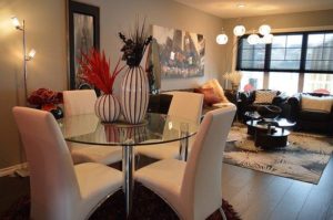 A tidy living room with a table and chairs and strategically placed lighting that helps you to effectively show your property.