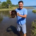 Clarksville TN Realtor Ron Dayley holding a horseshoe crab. Ron Dayley is Rated #4 in the state of TN and #1 in Clarksville TN for the past 4 years by Top Ranked Realtors. Your Clarksville TN Realtor is Ron Dayley of Epique Realty.