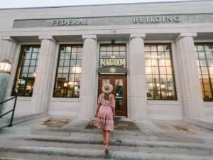 Woman in dress walking into The Mailroom restaurant in Clarksville TN.